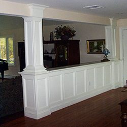 Paneled wainscot divider with built-in cabinet & column