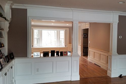 2 paneled columns tie in nicely with the wainscot and frame the opening. Now the two rooms flow together.