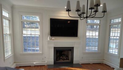 Custom Heater Covers compliment a fireplace mantle.